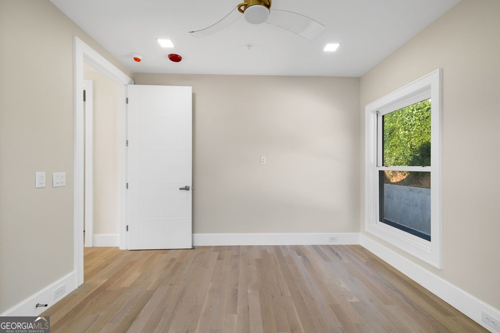 1281 East Main Street Blue Ridge, GA 30513 - Photo 6 of 19 an empty room with wooden floor and windows