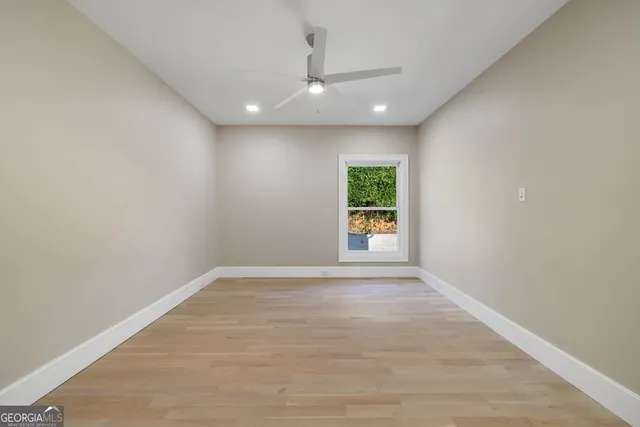 an empty room with a window and a fireplace