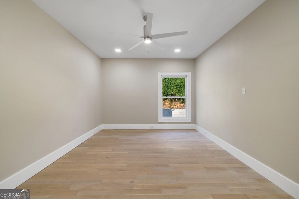 1281 East Main Street Blue Ridge, GA 30513 - Photo 10 of 19 an empty room with a window and a fireplace