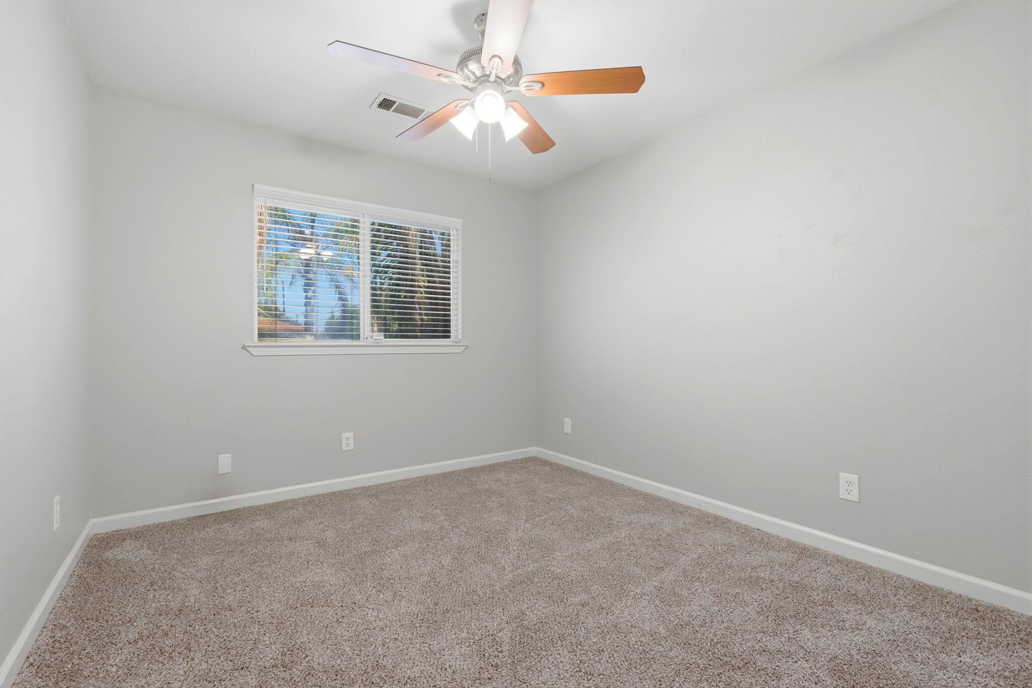 481 Katelyn Court Exeter, CA 93221 - Photo 11 of 33 an empty room with windows and fan