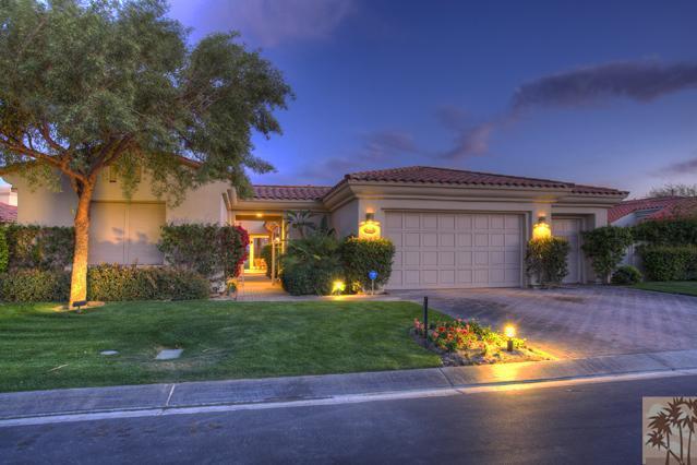 a view of a house with a yard fire pit and outdoor seating