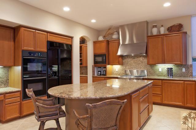 308 Loch Lomond Road Rancho Mirage, CA 92270 - Photo 12 of 25 a kitchen with stainless steel appliances granite countertop a stove refrigerator sink and cabinets