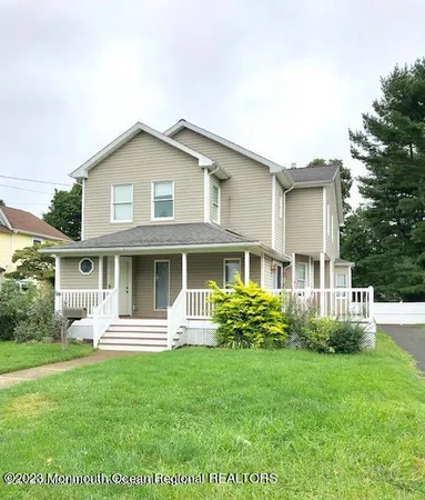 a front view of a house with a yard table and chairs