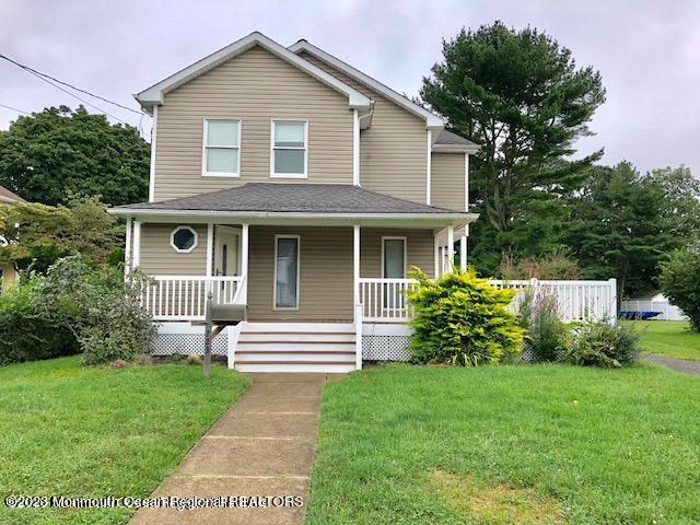 223 Lewis Street Oakhurst, NJ 07755 - Photo 2 of 12 a front view of a house with garden
