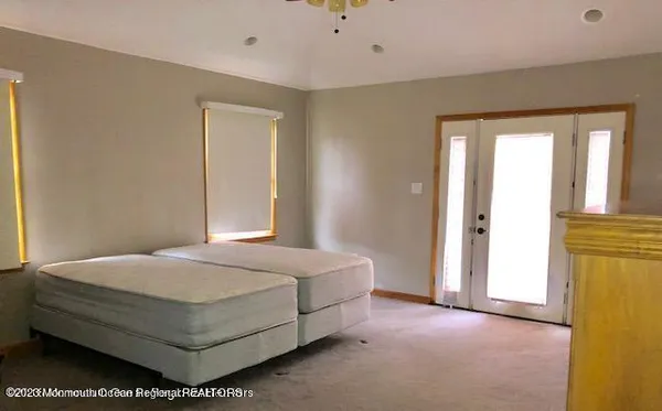 a bedroom with a bed and a window