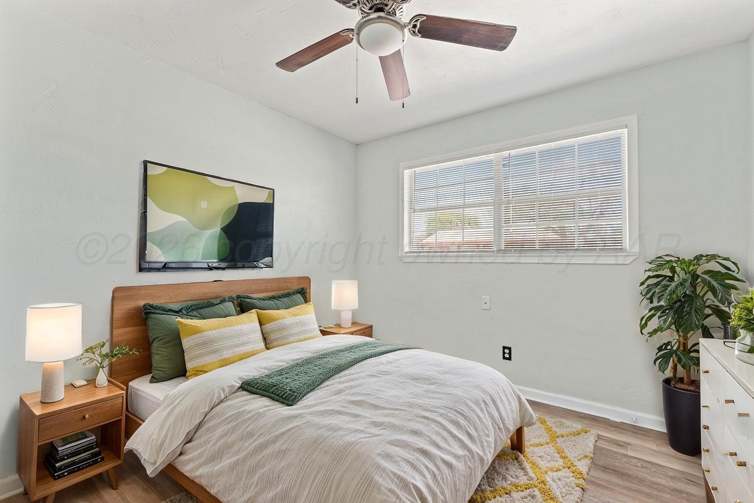 322 Poplar Street Amarillo, TX 79107 - Photo 11 of 42 a bedroom with a bed and a potted plant