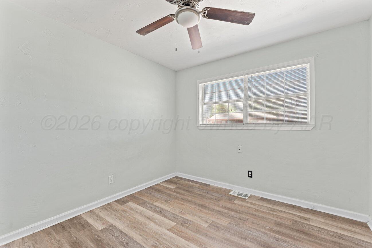 322 Poplar Street Amarillo, TX 79107 - Photo 12 of 42 a view of empty room with wooden floor and fan