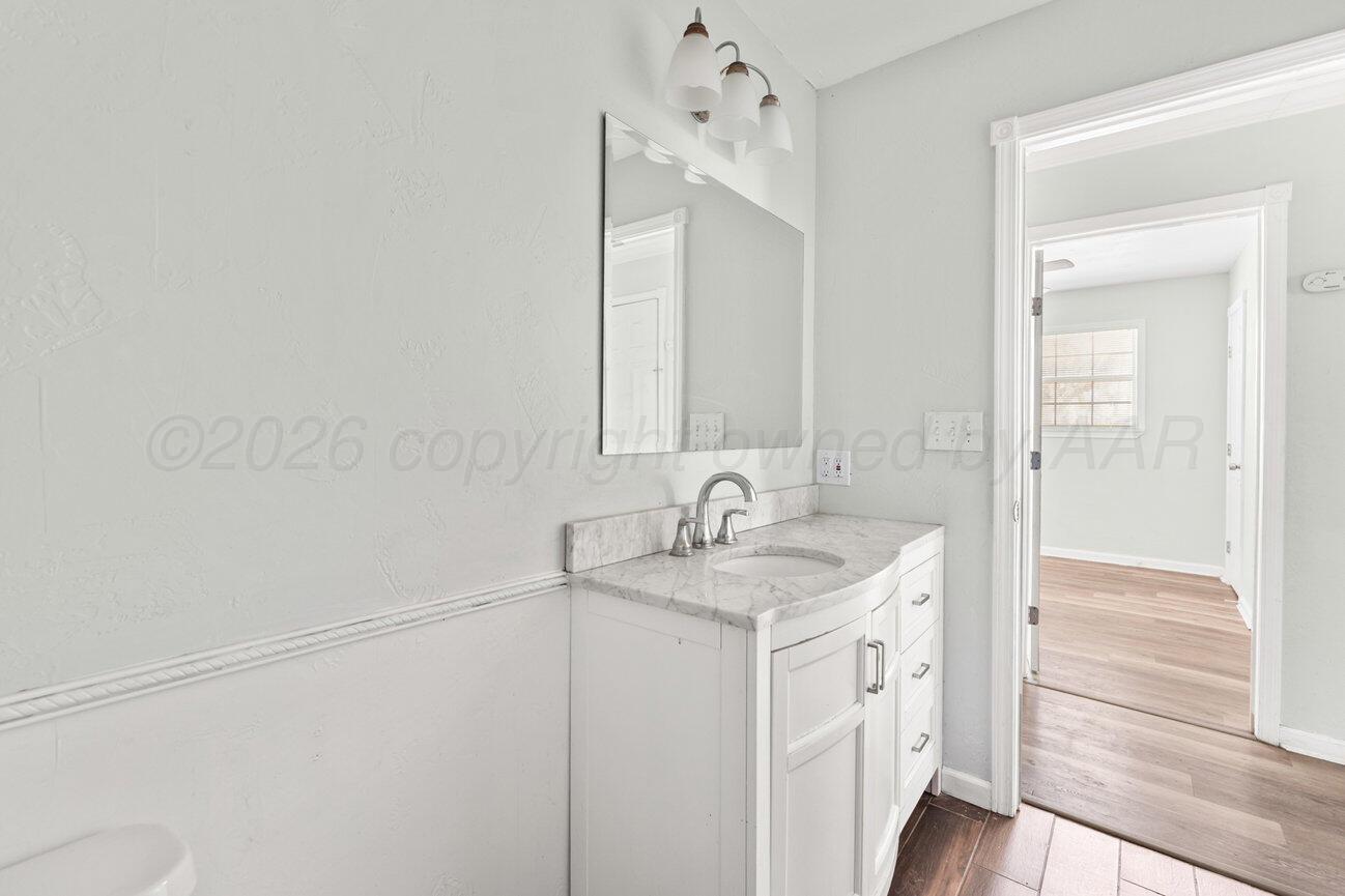 322 Poplar Street Amarillo, TX 79107 - Photo 16 of 42 a bathroom with a sink and a mirror