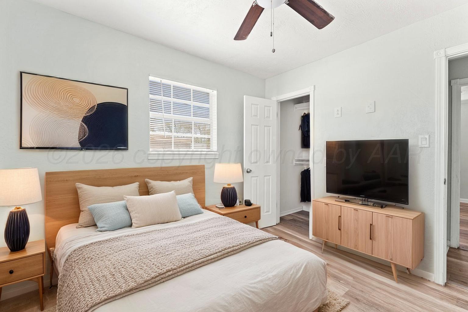 322 Poplar Street Amarillo, TX 79107 - Photo 21 of 42 a bedroom with a bed and a flat screen tv