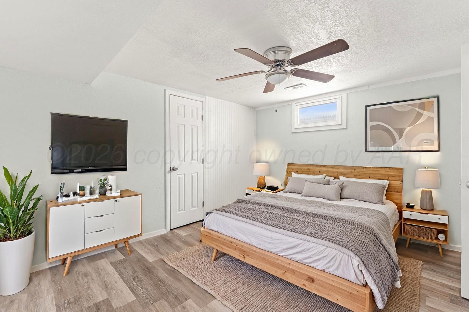 322 Poplar Street Amarillo, TX 79107 - Photo 24 of 42 a bedroom with a bed and a flat screen tv