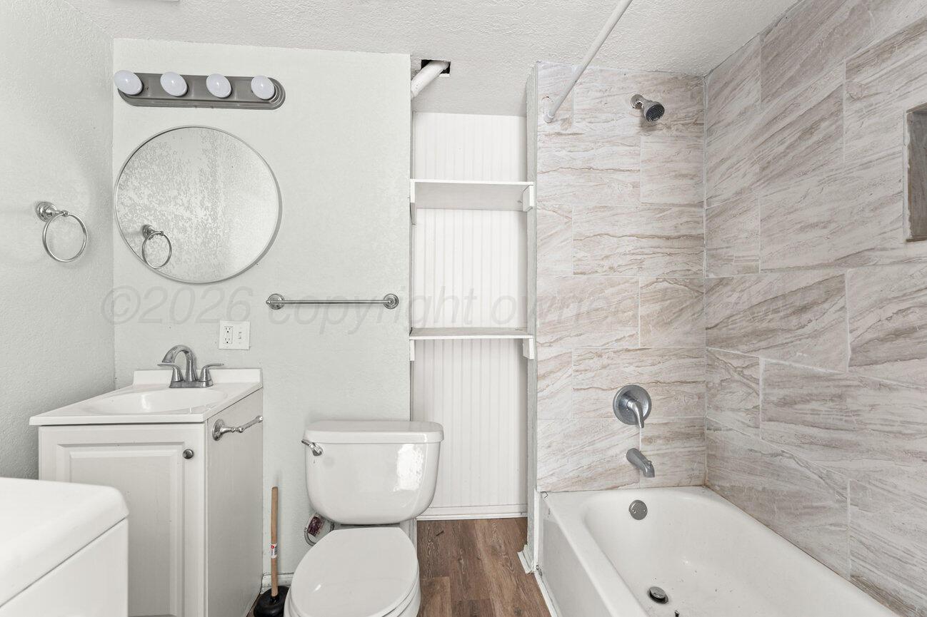 322 Poplar Street Amarillo, TX 79107 - Photo 26 of 42 a bathroom with a sink a toilet and shower