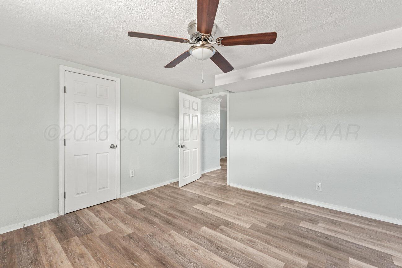 322 Poplar Street Amarillo, TX 79107 - Photo 27 of 42 a view of a big room with wooden floor and a ceiling fan