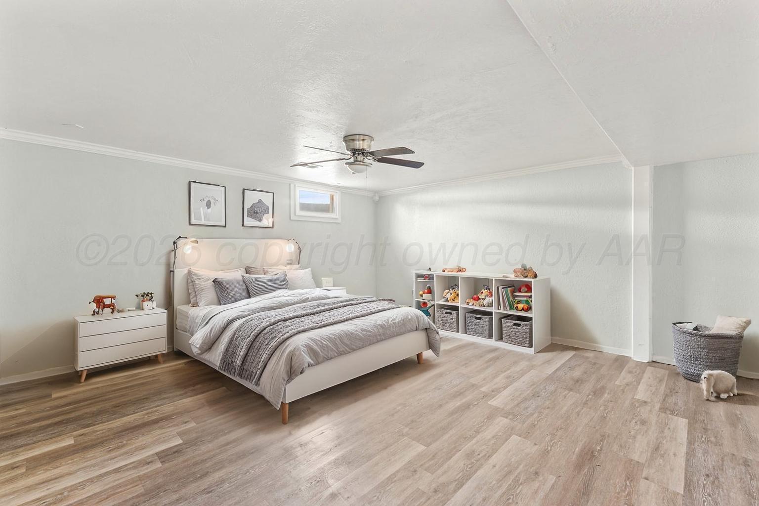 322 Poplar Street Amarillo, TX 79107 - Photo 30 of 42 a bedroom with a bed and a chandelier