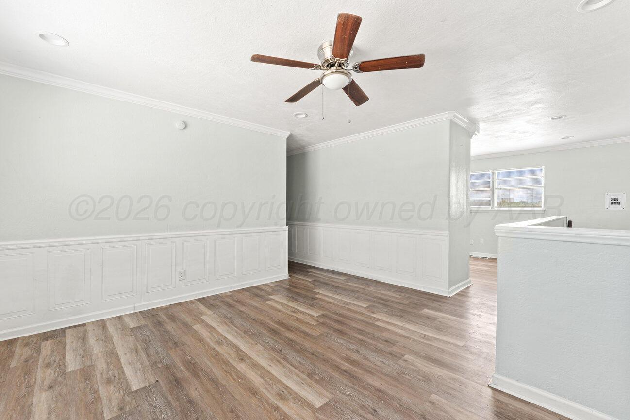 322 Poplar Street Amarillo, TX 79107 - Photo 4 of 42 wooden floor in an empty room with a window
