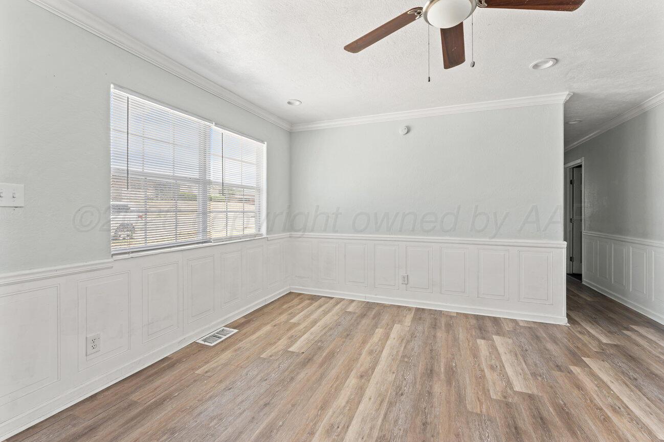 322 Poplar Street Amarillo, TX 79107 - Photo 5 of 42 an empty room with wooden floor and windows