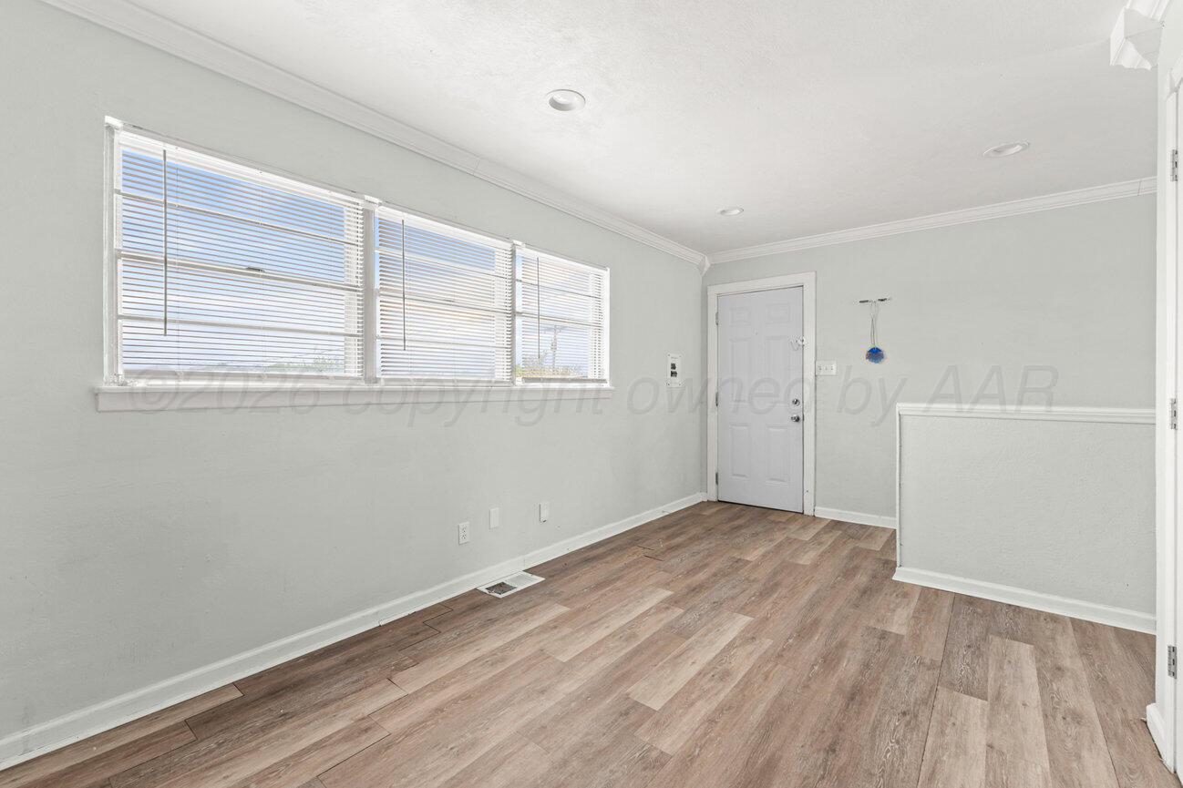 322 Poplar Street Amarillo, TX 79107 - Photo 10 of 42 an empty room with wooden floor and windows