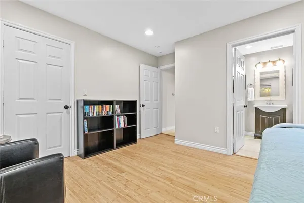 a view of a bedroom with wooden floor and closet