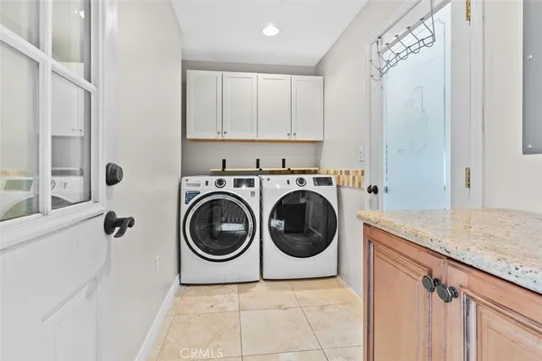 a utility room with sink dryer and washer
