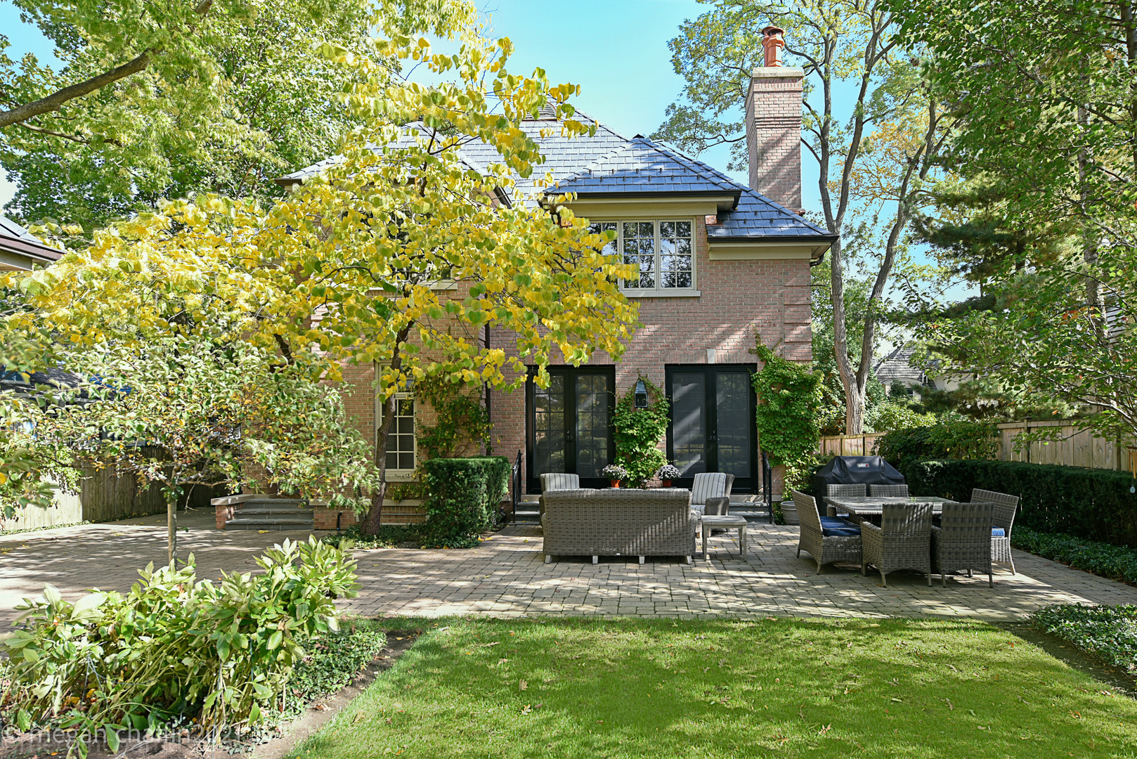 102 Church Road Winnetka, IL 60093 - Photo 42 of 46 a view of a chair and tables in the backyard of the house