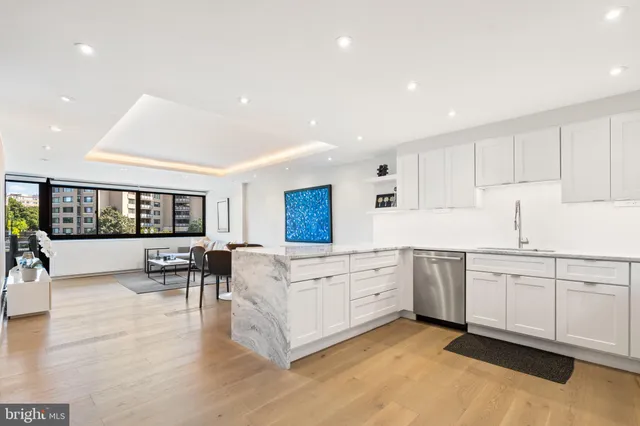 a kitchen with granite countertop appliances cabinets and a sink
