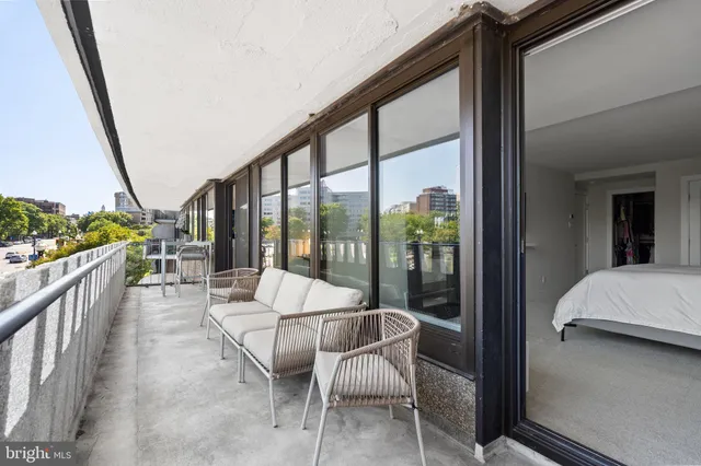a bedroom with a large window and a flat screen tv