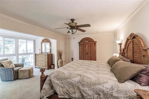 a bedroom with a large bed and a chandelier