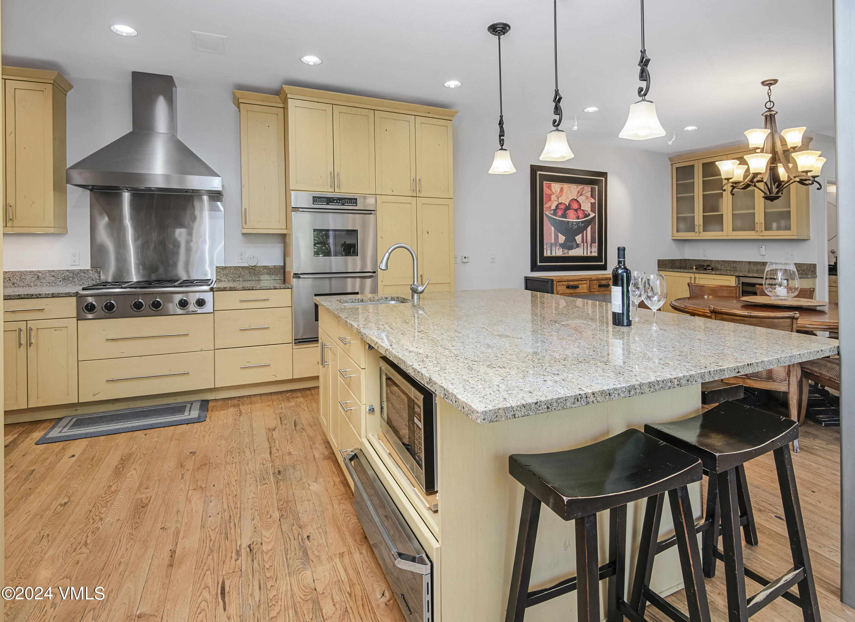 1968 Vermont Road Vail, CO 81657 - Photo 15 of 69 a kitchen with granite countertop a stove a sink a counter space and wooden floor