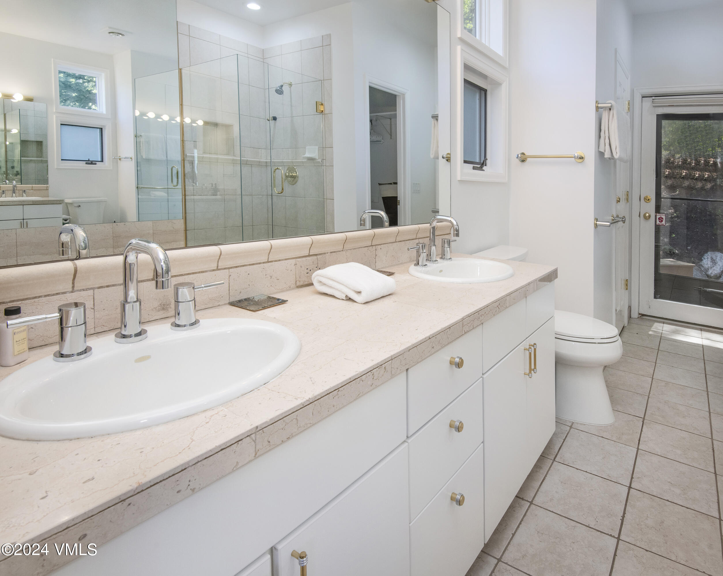 1968 Vermont Road Vail, CO 81657 - Photo 30 of 69 a bathroom with a double vanity sink toilet and shower
