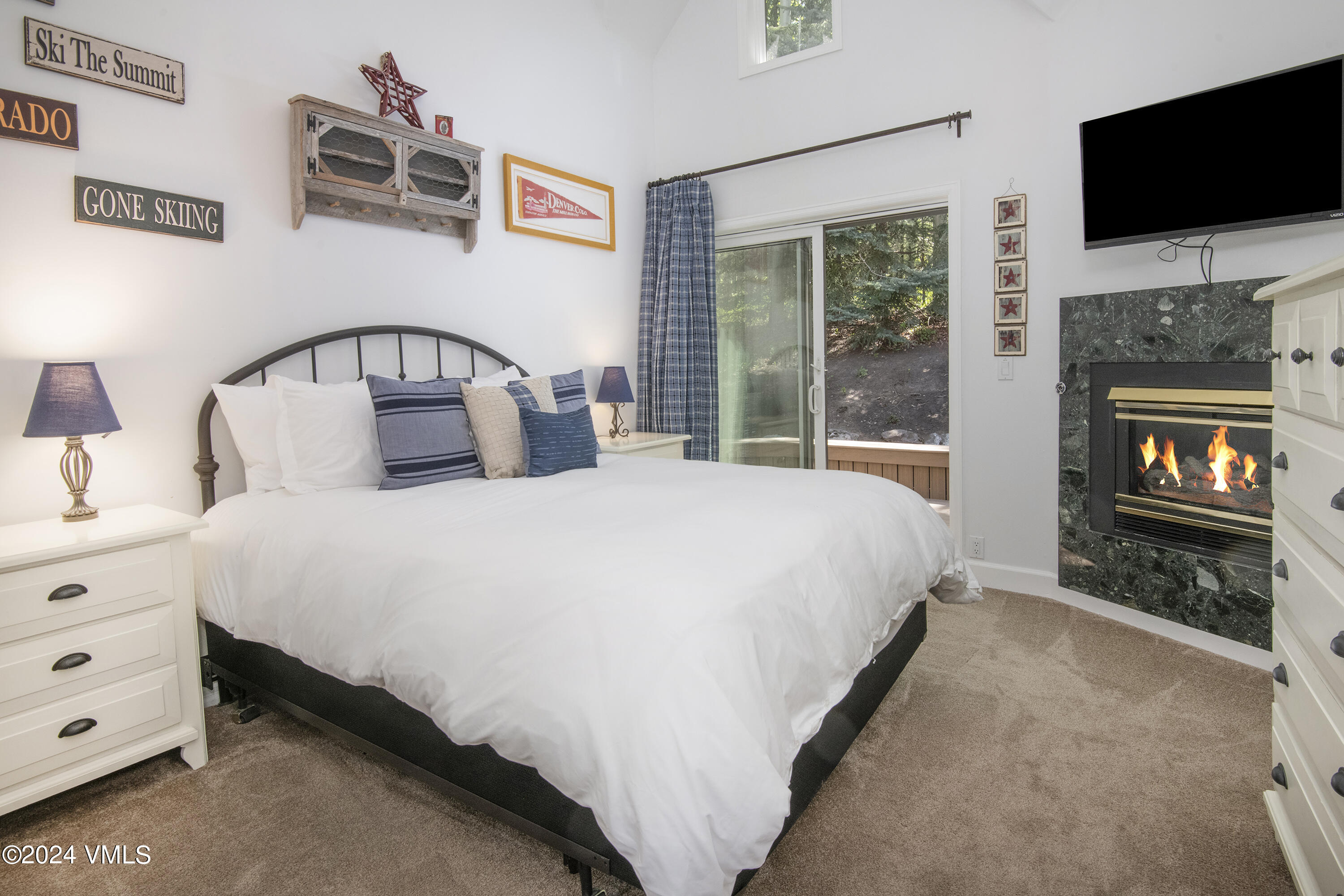 1968 Vermont Road Vail, CO 81657 - Photo 32 of 69 a bedroom with a bed and a flat tv screen on dresser
