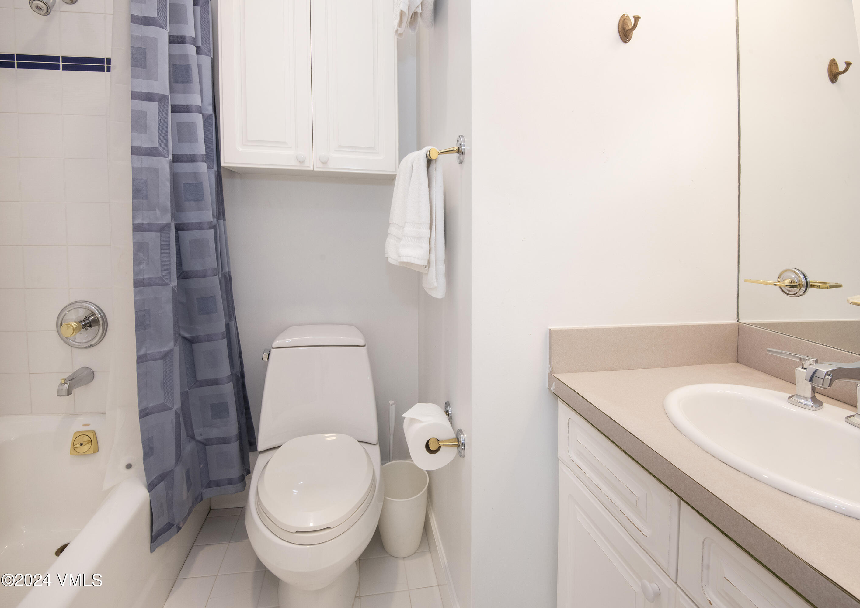 1968 Vermont Road Vail, CO 81657 - Photo 34 of 69 a bathroom with a granite countertop toilet sink and mirror