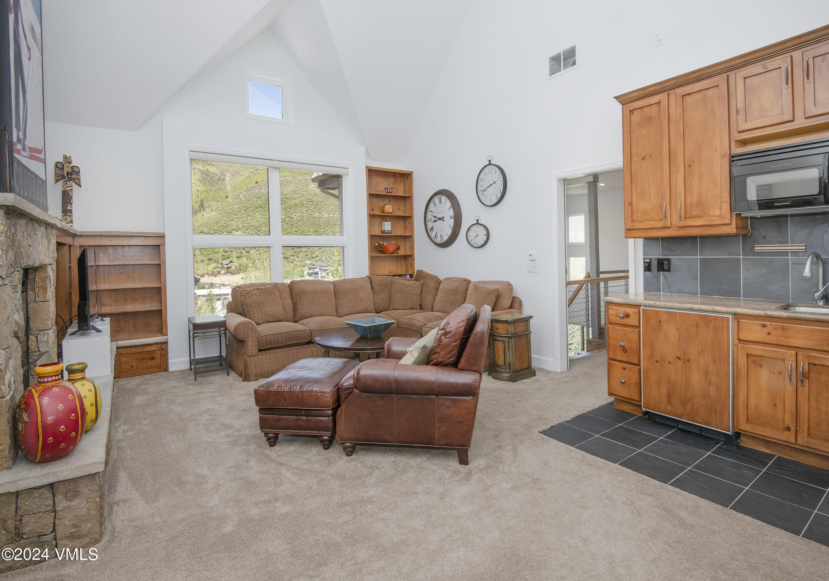 1968 Vermont Road Vail, CO 81657 - Photo 40 of 69 a living room with furniture a flat screen tv and a window