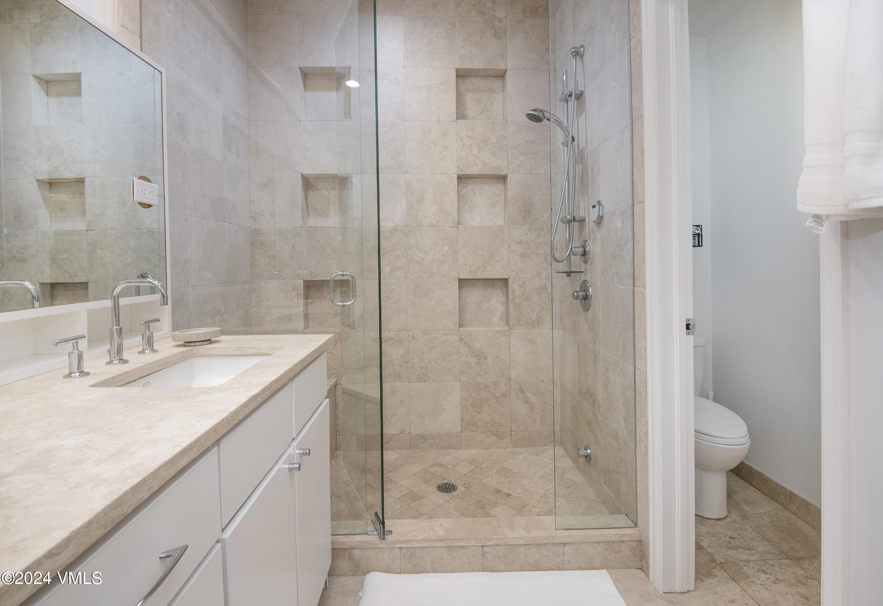 1968 Vermont Road Vail, CO 81657 - Photo 47 of 69 a bathroom with a shower sink vanity and mirror