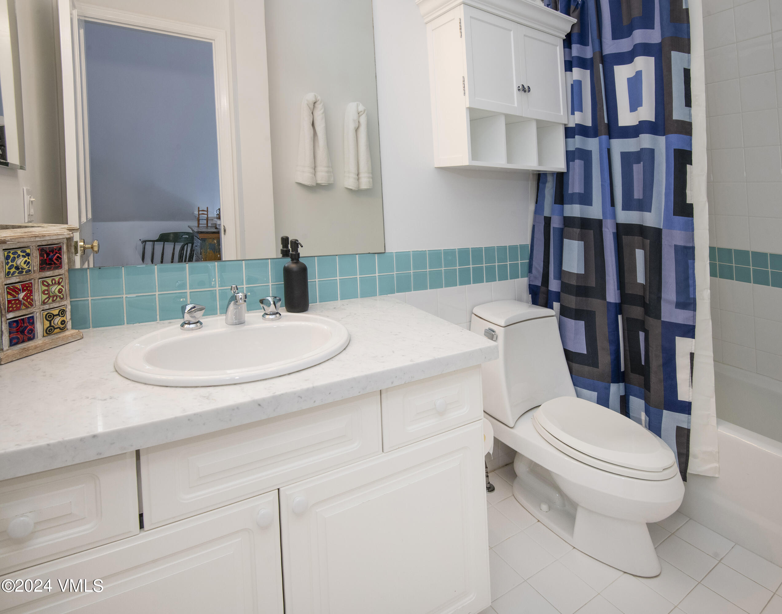 1968 Vermont Road Vail, CO 81657 - Photo 53 of 69 a bathroom with a sink a toilet and a mirror