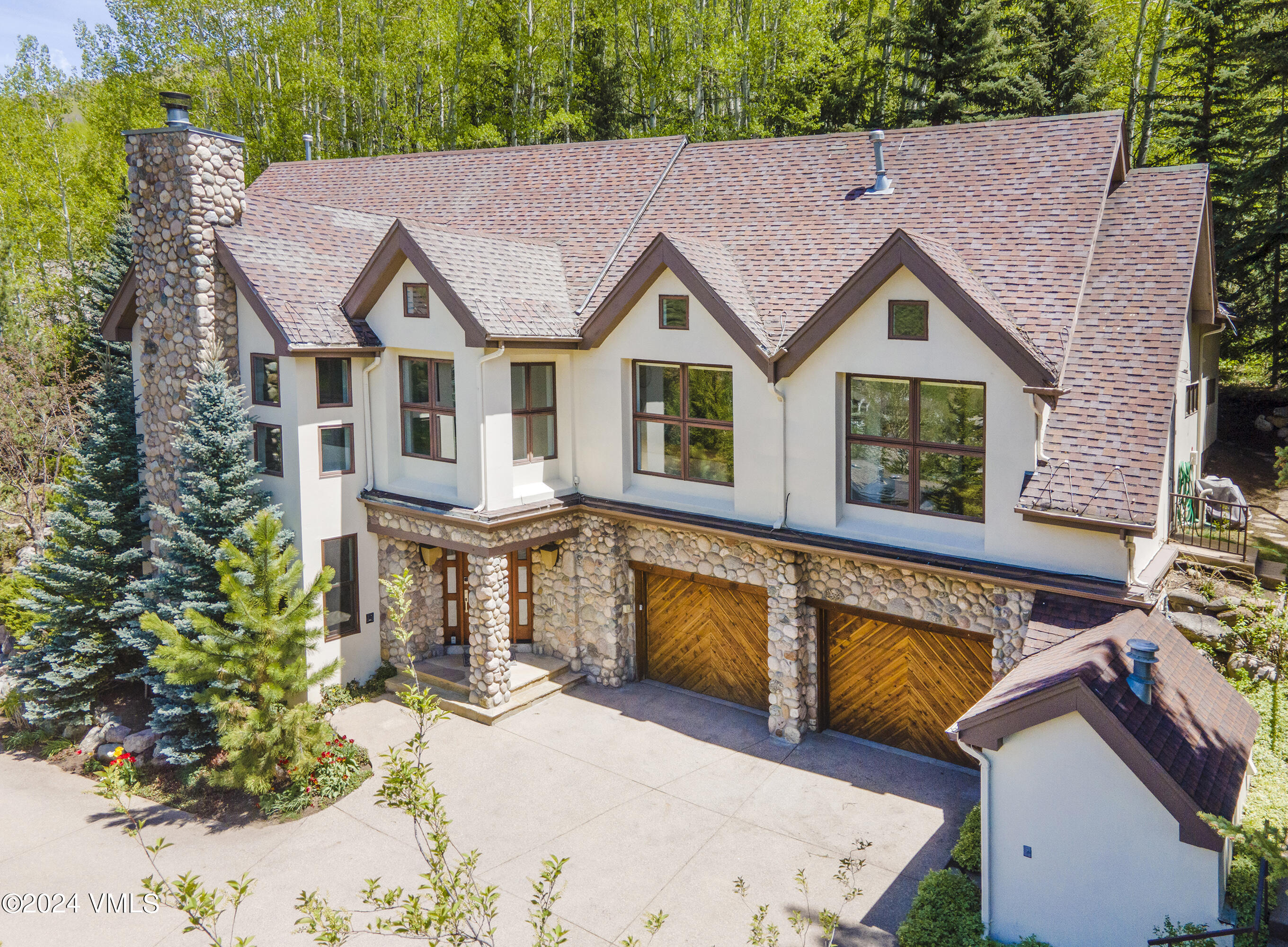 1968 Vermont Road Vail, CO 81657 - Photo 69 of 69 a view of a white house with large windows and a table and chairs