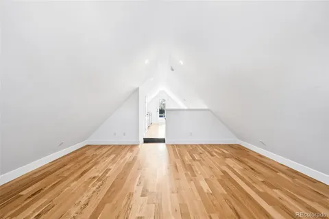 a view of a room with wooden floor and white walls