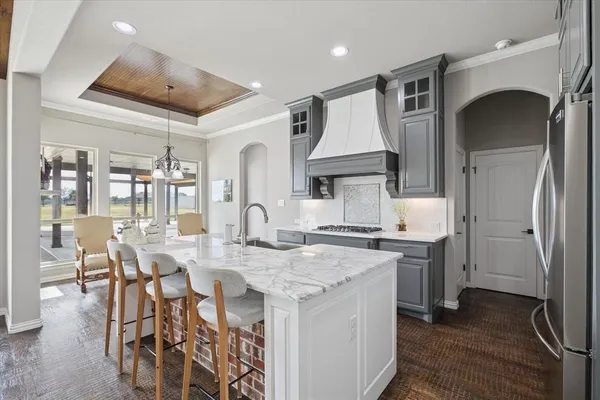 a kitchen with a table chairs stove and cabinets