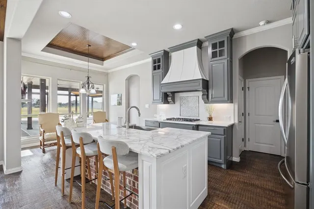 a kitchen with a table chairs stove and cabinets