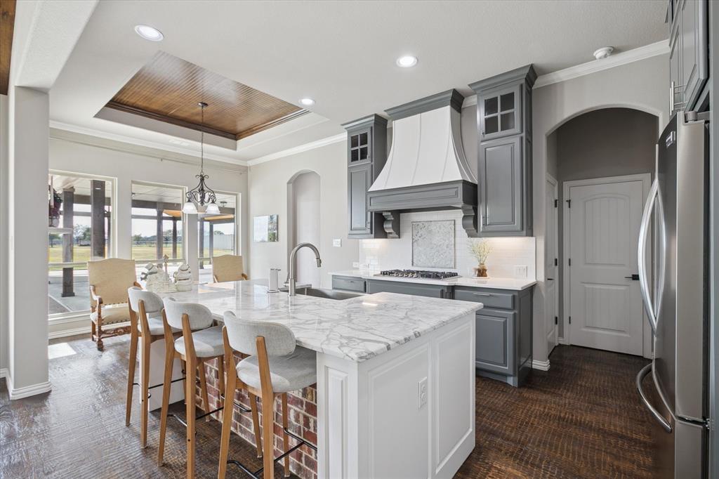 542 Pierce Road Red Oak, TX 75154 - Photo 14 of 40 a kitchen with a table chairs stove and cabinets