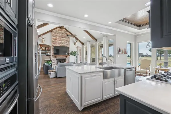 a kitchen with stainless steel appliances granite countertop a sink stove and refrigerator