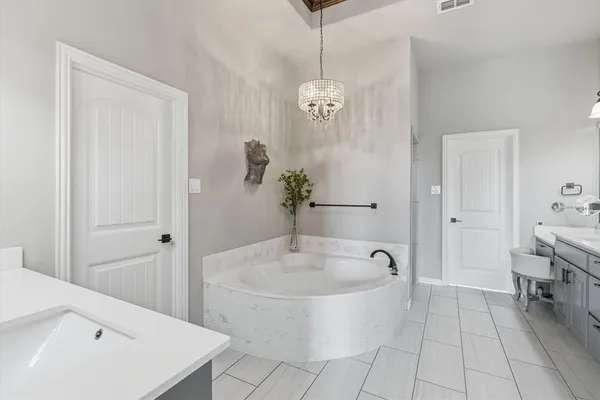 a spacious bathroom with a double vanity sink and a bathtub