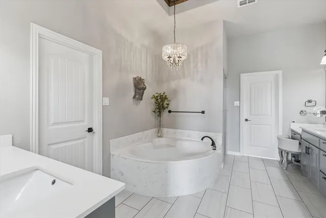 a spacious bathroom with a double vanity sink and a bathtub