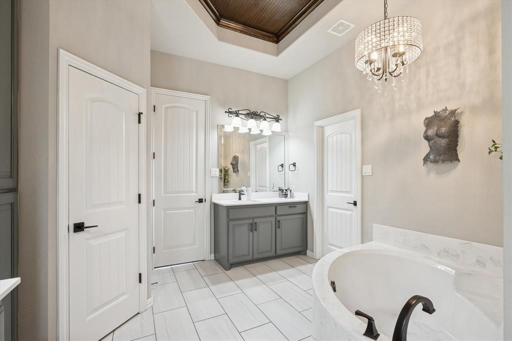 542 Pierce Road Red Oak, TX 75154 - Photo 24 of 40 a spacious bathroom with a granite countertop sink a mirror and a bathtub