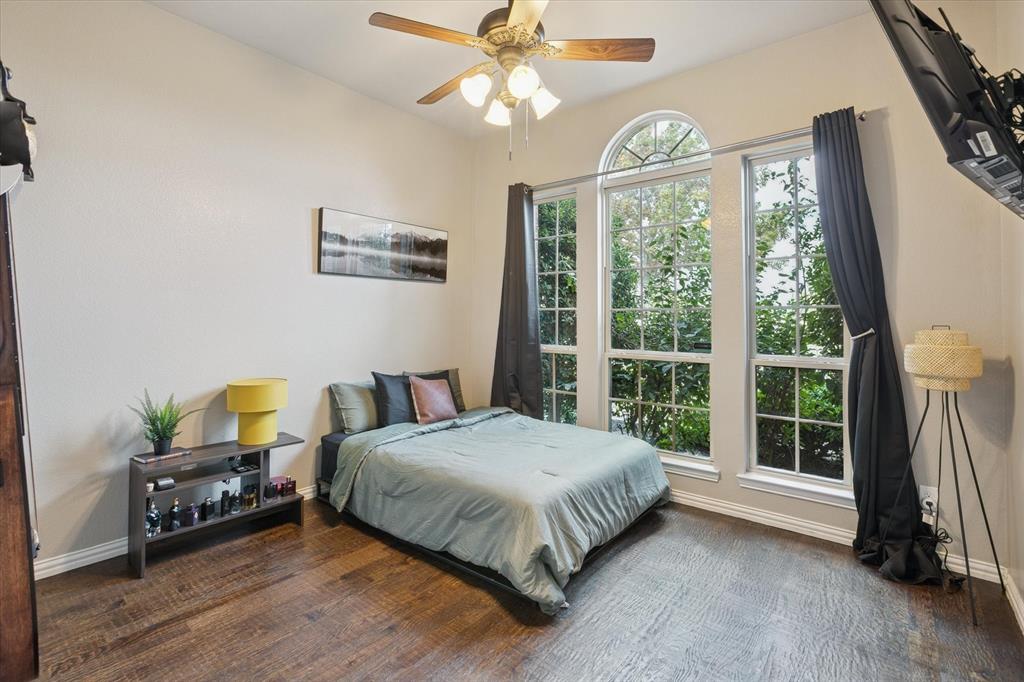 542 Pierce Road Red Oak, TX 75154 - Photo 26 of 40 a spacious bedroom with a bed a chandelier and a large window