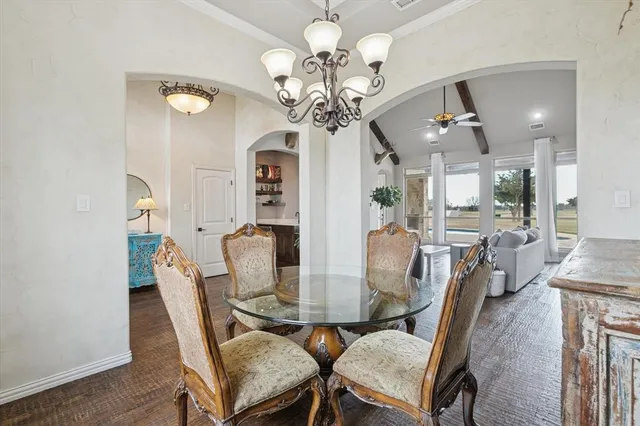 a view of a dining room with furniture and a chandelier