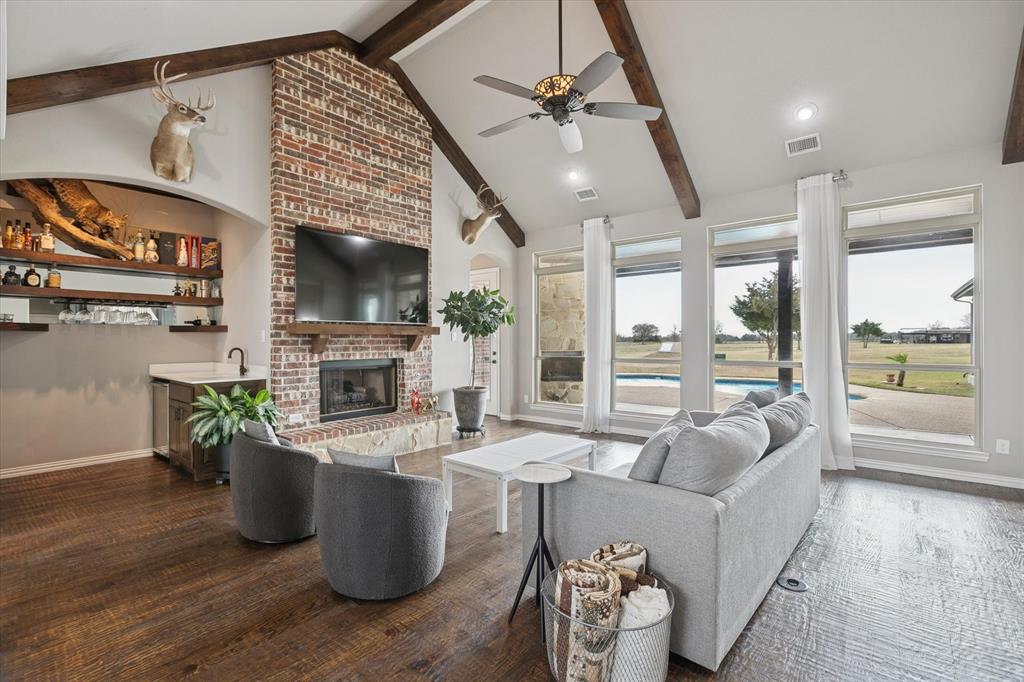 542 Pierce Road Red Oak, TX 75154 - Photo 9 of 40 a living room with furniture a fireplace and a floor to ceiling window