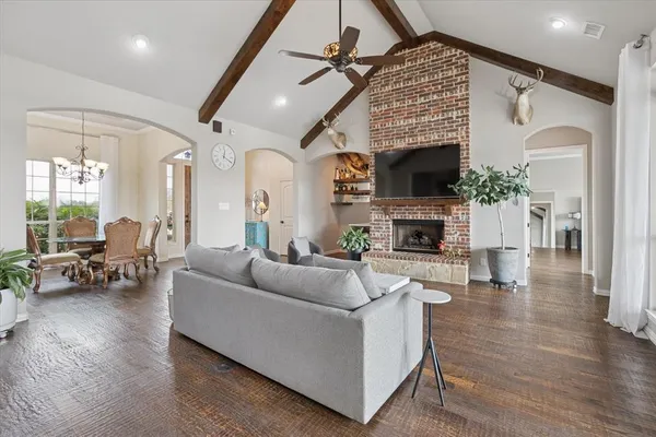 a living room with furniture a fireplace and a flat screen tv