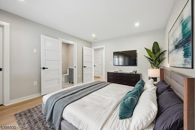 12 Rocky Point Road West Milford, NJ 07421 - Photo 24 of 50 a bedroom with a large bed and a flat screen tv