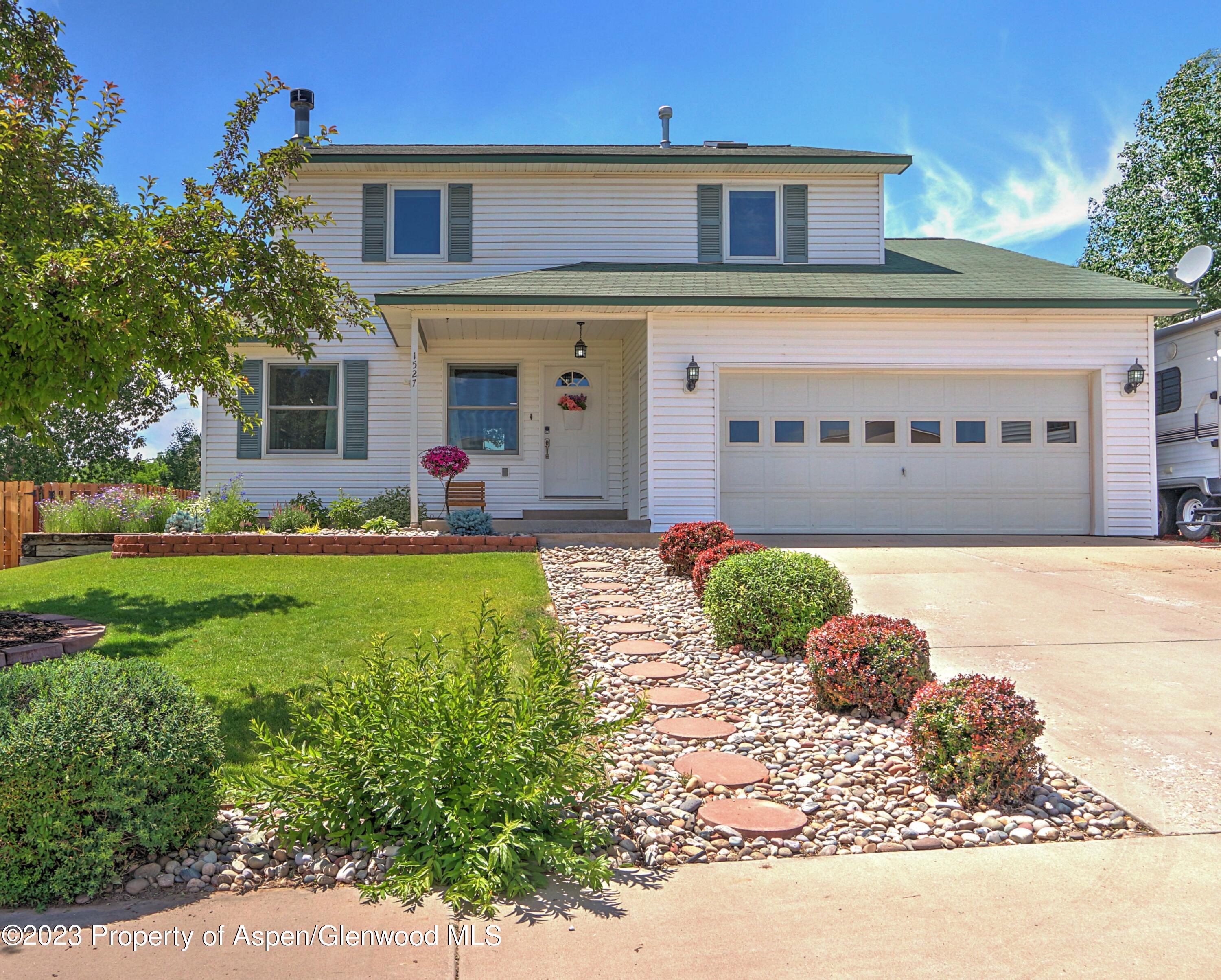 1527 Graham Court Rifle, CO 81650 - Photo 1 of 32 a front view of a house with garden