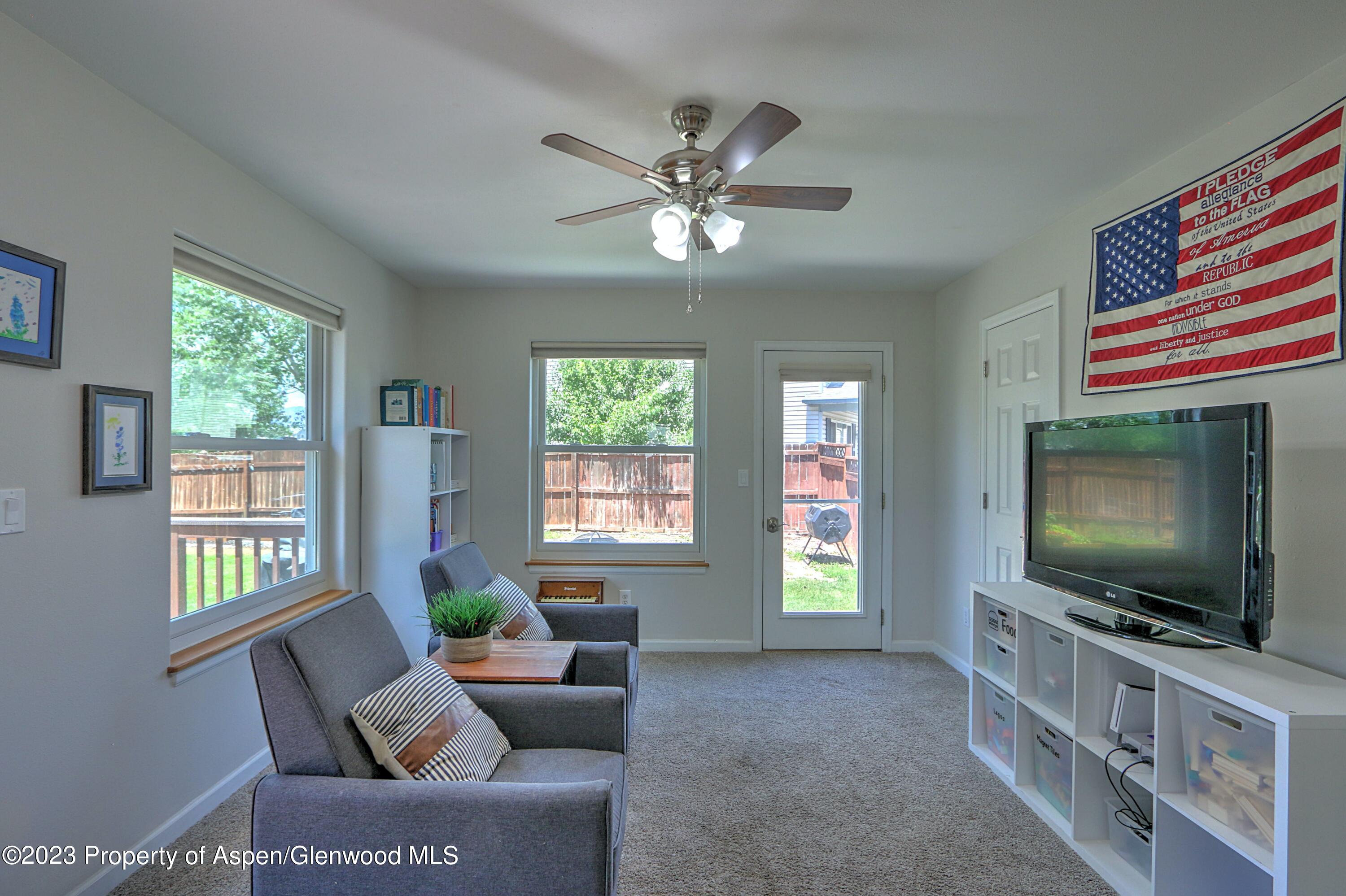 1527 Graham Court Rifle, CO 81650 - Photo 14 of 32 a living room with furniture and a flat screen tv
