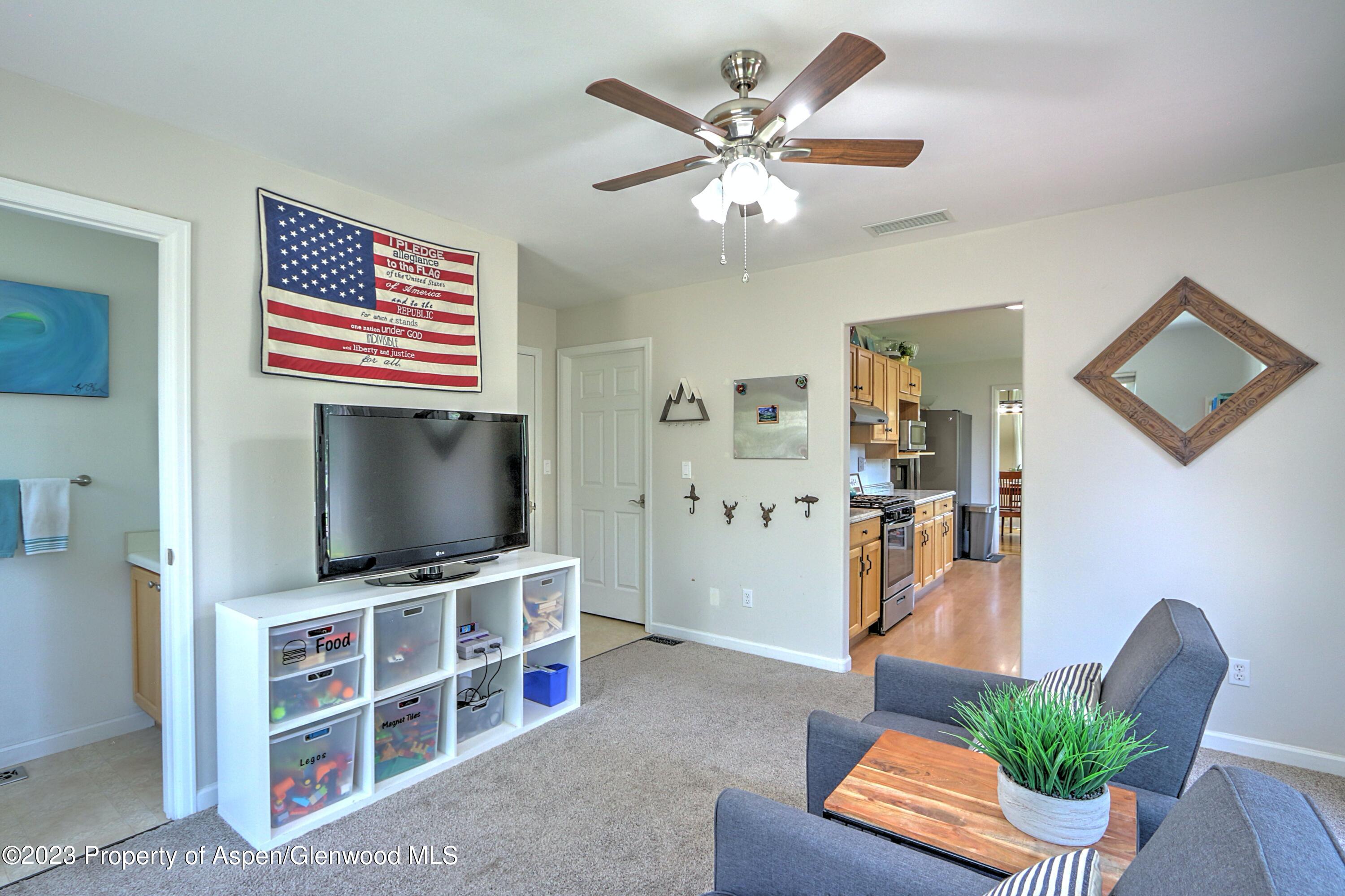 1527 Graham Court Rifle, CO 81650 - Photo 15 of 32 a living room with furniture and a flat screen tv